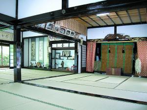 an empty room with a door in a building at Shukubo Daishinbo in Tsuruoka