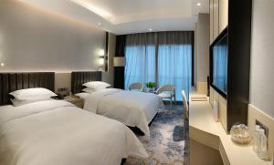 Voodi või voodid majutusasutuse Chongqing Liyuan Hotel toas
