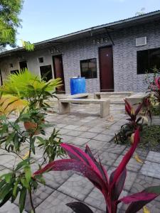 a courtyard with benches and plants in front of a building at Katrina's Dorm in Tarlac