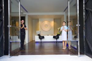 
a woman and a man standing in a room at AYA Boutique Hotel Pattaya - SHA Plus in Pattaya
