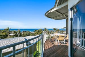 a balcony with a table and chairs and the ocean at Andari Holiday Apartments in Sunshine Beach +65 photos