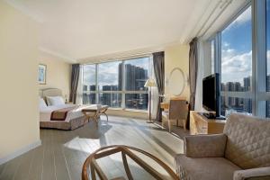 una camera d'albergo con un letto e una grande finestra di Harbour Plaza Resort City a Hong Kong