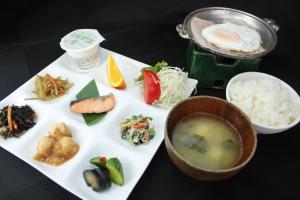 a plate of food with a bowl of soup and rice at Oita Toranoyu in Kokonoe