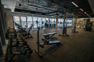a gym with rows of treadmills and exercise bikes at Diamond Twintower Apartment Hotel 鑽石雙星酒店式公寓 in Phnom Penh