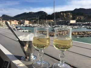 two glasses of white wine sitting on a table at Cassis et ses trésors in Cassis