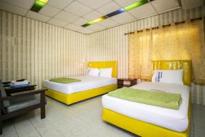 A bed or beds in a room at Bualuang HOTEL