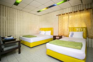Ένα ή περισσότερα κρεβάτια σε δωμάτιο στο Bualuang HOTEL