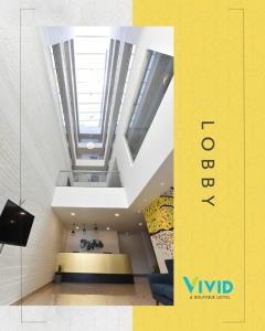 Postel nebo postele na pokoji v ubytování Vivid A Boutique Hotel