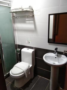 a bathroom with a toilet and a sink at Paragon Lutong Hotel in Lutong