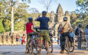 a group of people riding bikes in a park at Home Indochine D'angkor Hotel in Siem Reap