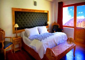 a bedroom with a large bed and a window at Hotel Grand Himalaya in Leh