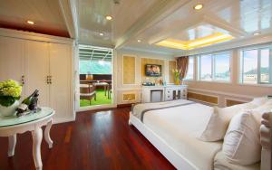 a large bedroom with a large bed and a table at Signature Halong Cruise in Ha Long