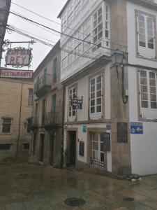 a building with a sign on the side of it at Hostal Forest in Santiago de Compostela