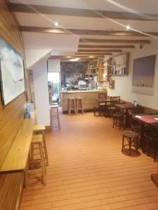 a restaurant with tables and chairs and a bar at Hostal Forest in Santiago de Compostela