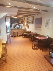 a restaurant with tables and chairs and a counter at Hostal Forest in Santiago de Compostela