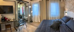 a bedroom with a blue bed and a living room at Al Sagraeto in Chioggia