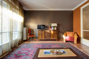 a living room with a table and a couch and a tv at Danube Apartment Váci in Budapest