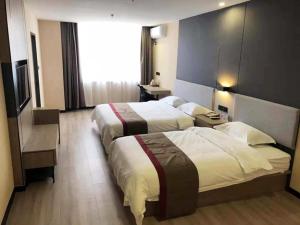 a hotel room with two beds and a large window at Thank Inn Plus Hotel Hebei Shijiazhuang Zhengding New District International Small Commodity City in Shijiazhuang