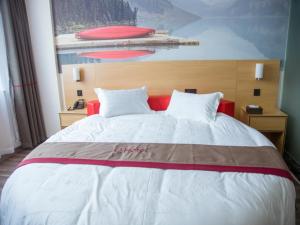 a bedroom with a large bed with a red headboard at Thank Inn Plus Hotel Jiangxi Nanchang Gaoxin Development Zone 2nd Huoju Road in Nanchang