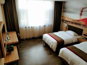 a hotel room with two beds and a window at Thank Inn Plus Hotel Shandong Binzhou Huimin County Huji Driving Test Center in Binzhou