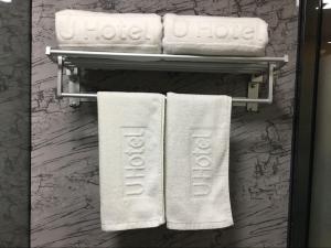 a bathroom with white towels on a rack at Thank Inn Plus Hotel Hebei Xingtai Nangong Duanlutou Town in Duanlutou