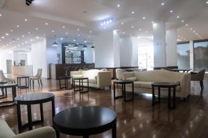 a lobby with couches and tables and chairs at BON Hotel Ikeja Residence in Ikeja