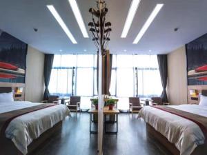a hotel room with two beds and a large window at Thank Inn Plus Hotel Anhui Tongling Tongguan District Xihuchuncheng in Tongling