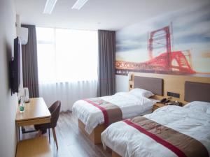 a hotel room with two beds and a desk with a desk at Thank Inn Plus Hotel Jiangxi Nanchang Gaoxin Development Zone 2nd Huoju Road in Nanchang