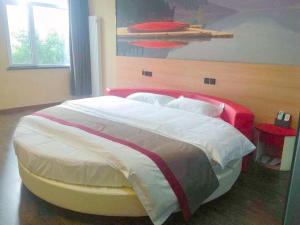 a bedroom with a large bed with a red headboard at Thank Inn Plus Hotel Hebei Handan Hanshan District Fu Southeast Street in Handan