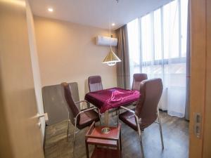 a dining room with a table and chairs and a window at Thank Inn Plus Hotel Anhui Tongling Tongguan District Darunfa in Tongling