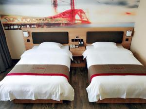 two beds in a hotel room with a view of a roller coaster at Thank Inn Plus Hotel Shandong Binzhou Huimin County Huji Driving Test Center in Binzhou