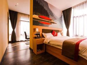 a bedroom with a bed and a red surfboard on the wall at Thank Inn Plus Hotel Anhui Tongling Tongguan District Xihuchuncheng in Tongling