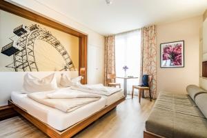 a hotel room with a bed and a large window at JUFA Hotel Wien in Vienna