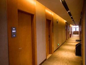 an empty hallway of an office building with a sign on the wall at Up And In Yunnan Dehongzhou Mangshi Street in Mangshi