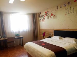 a hotel room with a bed and a window at Thank Inn Plus Hotel Shandong Jining High-tech District Huangtun Plaza Commercial Building in Jining