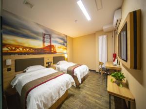 a hotel room with two beds and a painting on the wall at Thank Inn Plus Hotel Shandong Zibo Zhangdian District Jinjing Avenue Wanxianghui in Zibo