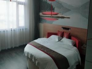 a bedroom with a large bed with a red headboard at Thank Inn Plus Hotel Hebei Cangzhou Botou Jinji Logistic Park in Cangzhou