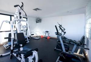 a gym with several tread machines in a room at Airport Business Flat Guarulhos - São Paulo in Guarulhos