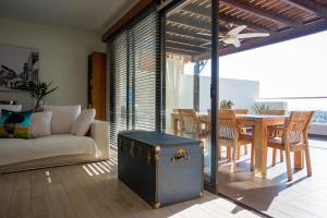 a living room with a couch and a table at Penthouse Duplex overlooking the Mediterranean in Larnaca