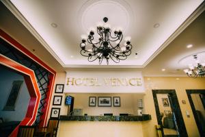a hotel entrance with a chandelier in a lobby at Hotel Venice in Kuala Lumpur