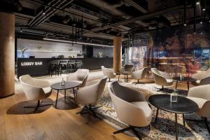 a waiting room with tables and chairs at Mamaison Residence Downtown Prague in Prague