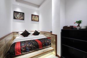 Postel nebo postele na pokoji v ubytování Zou Qu Ye Travel Hotel