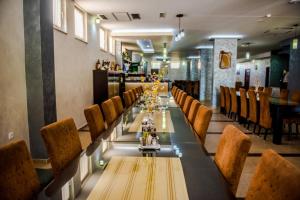a long dining room with a long table and chairs at Hotel Villa Monako in Međugorje