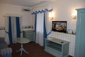 a small room with a table and a mirror at Готель Баварія in Poltava