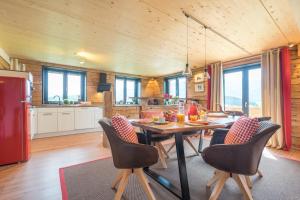 a kitchen and dining room with a table and chairs at Ferienwohnungen Alpentraum - Lieblingsplätzle in Bolsterlang +17 photos