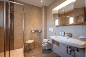 a bathroom with a sink and a shower at Haus Margreth in Ellmau +20 photos