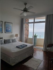 a bedroom with a bed and a large window at 105 Sea Lodge in Durban