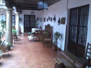 a living room with tables and chairs in a building at Los Girones Pacheco in Villanueva de los Infantes