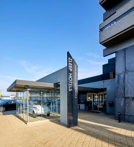 a car dealership with a sign in front of it at Zleep Hotel Aarhus Viby in Aarhus