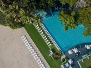 an overhead view of a resort swimming pool with palm trees at Veranda Resort & Villas Hua Hin Cha Am in Cha Am